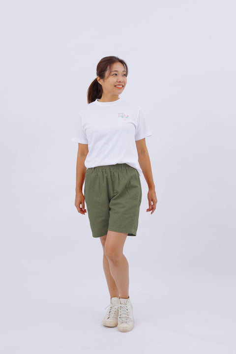 Full-body front view of the woman in the "Dove" T-shirt and shorts, walking with a relaxed pose.
