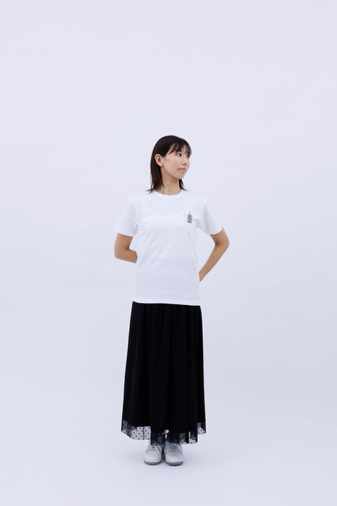Full-body front view of the woman in the "Five-story Pagoda & Kaiju Monster" T-shirt and long black skirt, standing casually.