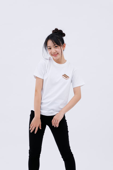 Front view of a smiling woman wearing the white "Takoyaki" T-shirt and black pants, leaning slightly forward with one hand on her hip.