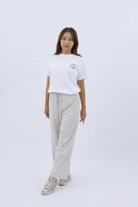 Full-body front view of the woman in the "Mochi-tsuki" T-shirt and beige pants, standing casually.