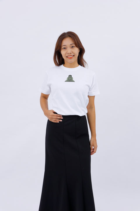 Front view of a smiling woman wearing the white "Kamakura Daibutsu" T-shirt and a long black skirt.
