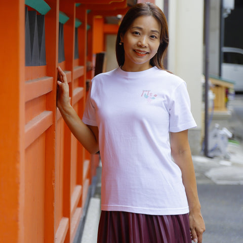 A woman wearing a T-shirt with a dove design.
