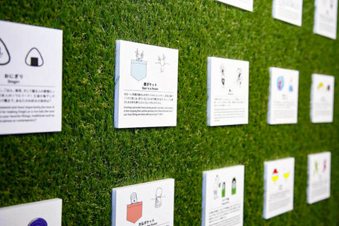 Shop wall with square cards showing illustrations and descriptions of ONE POINT T-shirt designs.