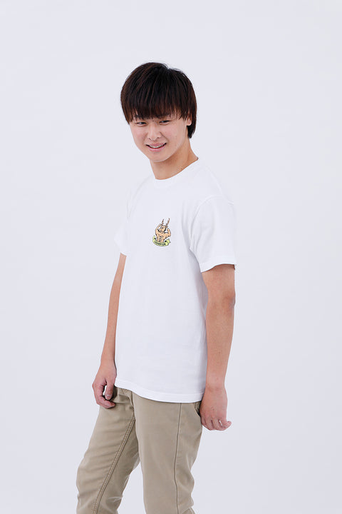 Side view of the man in the "Macho Deer" T-shirt and pants, standing with one hand by his side.