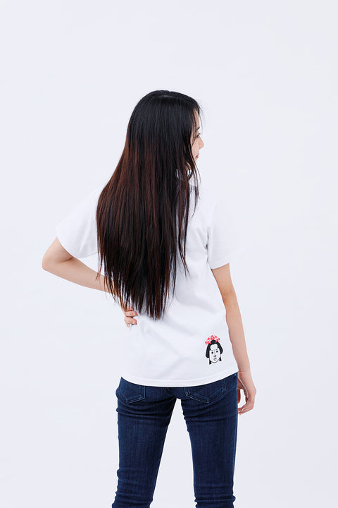 Rear view of the woman wearing the "Edo Face" T-shirt and jeans, showing the back print.