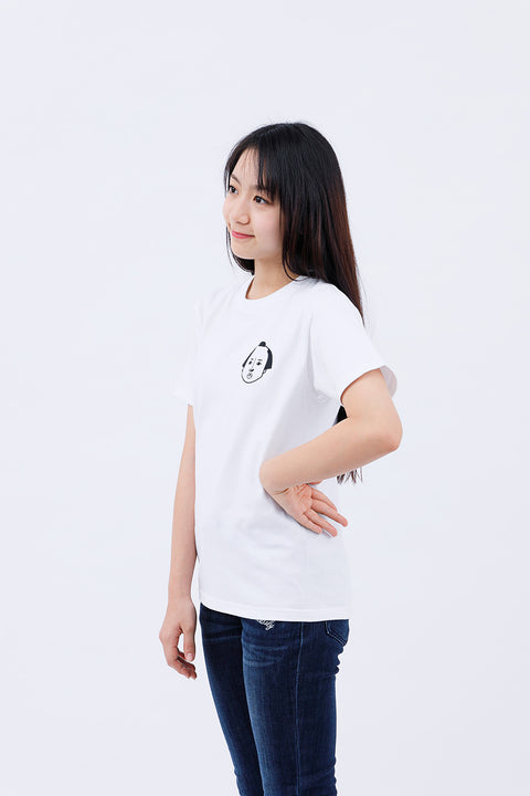 Side angled view of the woman in the "Edo Face" T-shirt and jeans, smiling gently.