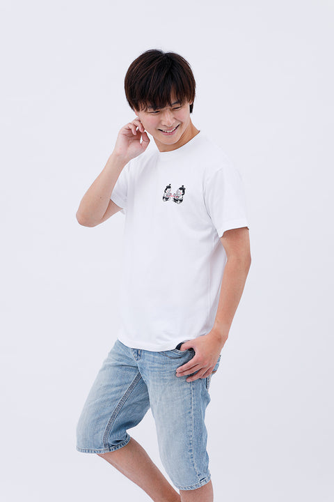 Side angled view of the man in the "Sumo Wrestler & Ayatori" T-shirt and jeans, looking downward.