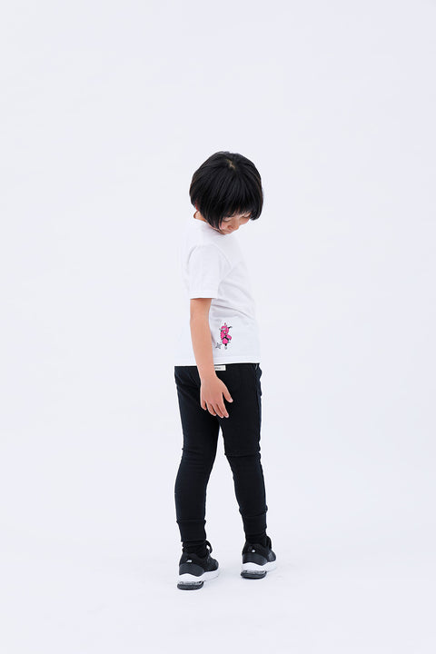 Full-body rear angled view of the child wearing the "Ninja" T-shirt and pants, walking.
