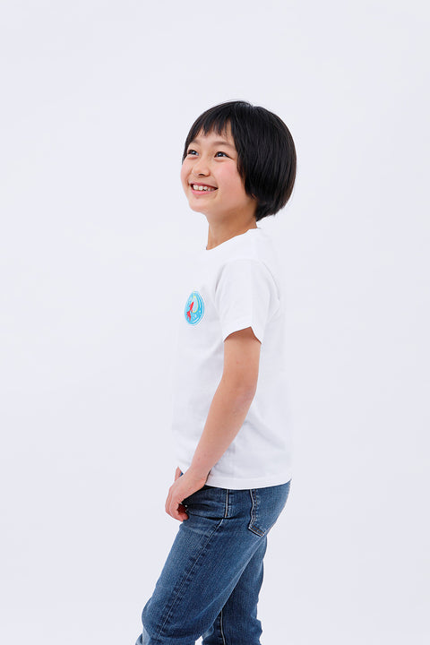Side view of the child in the "Kingyo Sukui" T-shirt and jeans, smiling softly.