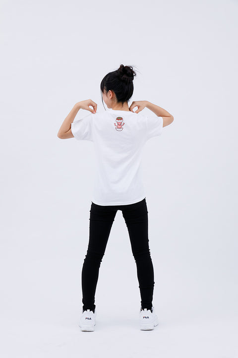 Full-body front view of the woman wearing the "Takoyaki" T-shirt and black pants, raising one arm.