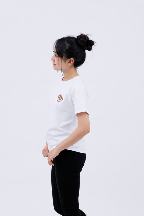 Side view of the woman in the "Takoyaki" T-shirt and black pants, looking ahead.