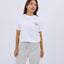 Angled front view of the woman wearing the "Mochi-tsuki" T-shirt and relaxed-fit pants.