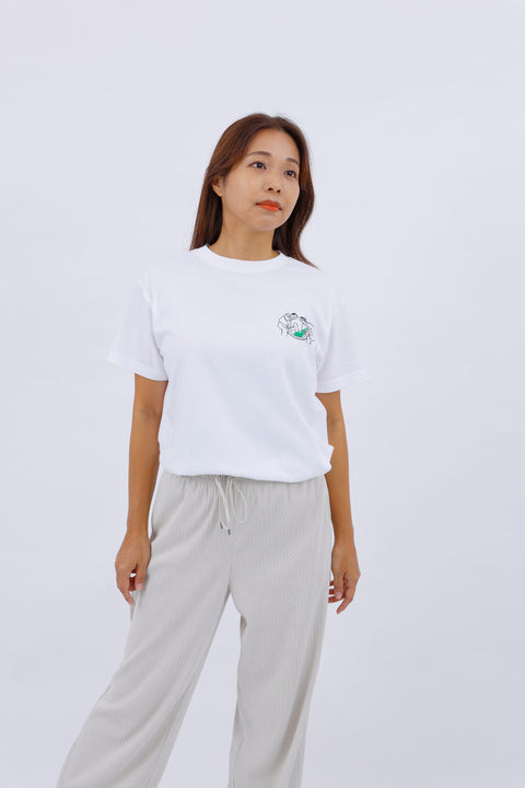 Angled front view of the woman wearing the "Mochi-tsuki" T-shirt and relaxed-fit pants.