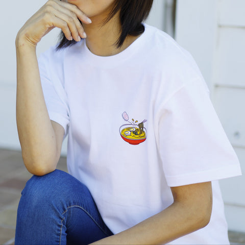 A woman wearing a T-shirt with a ramen design.